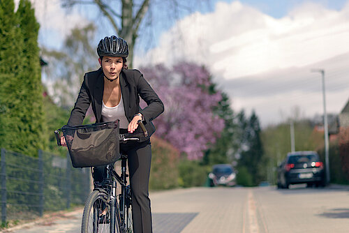 Young,Active,Businesswoman,Commuting,On,A,Bicycle,With,Protective,Helmet
