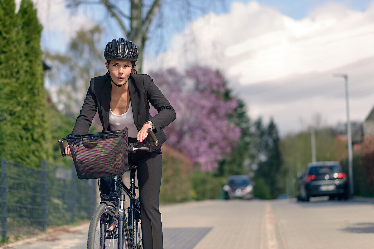 Young,Active,Businesswoman,Commuting,On,A,Bicycle,With,Protective,Helmet