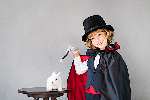 Child illusionist with cute rabbit